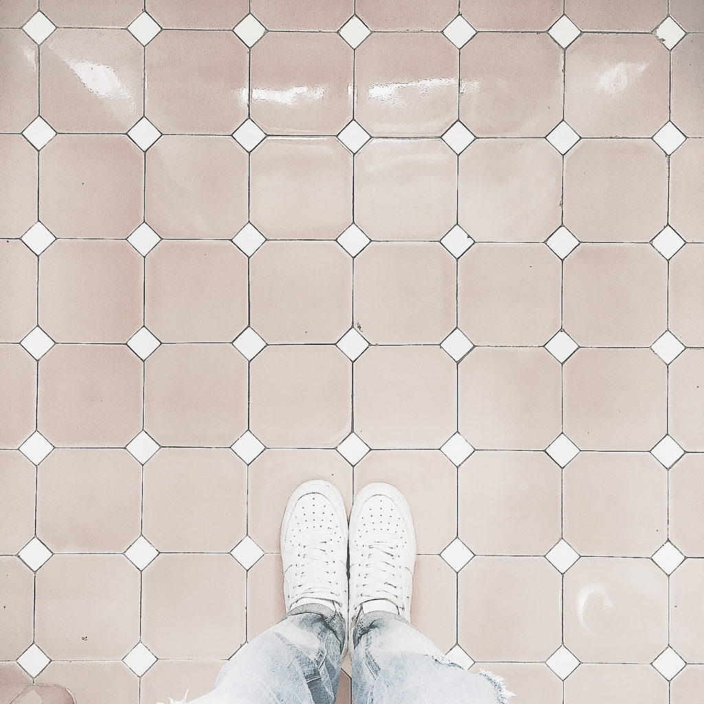 white tennis shoes on beige tile